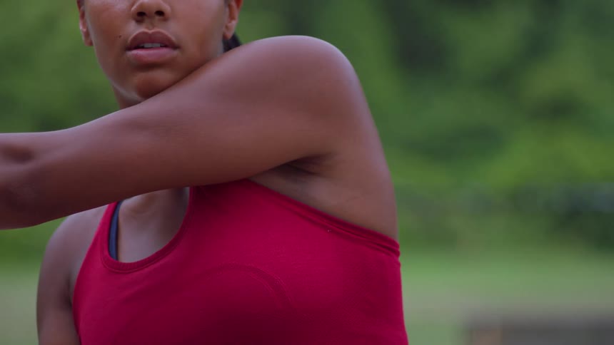 The woman stretches and hits the ball with her tennis racket