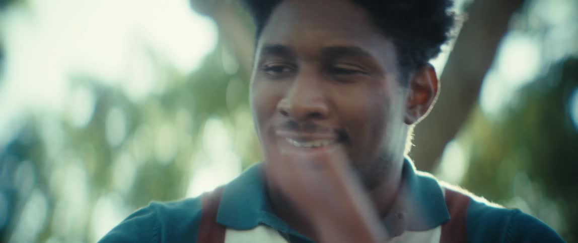 Man looks at the phone screen with a calm expression outdoors