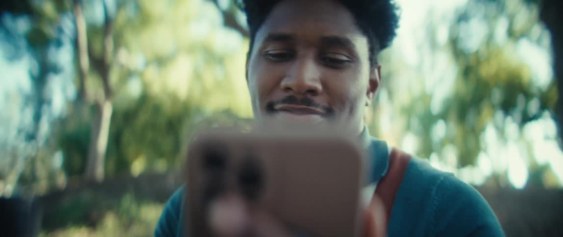 Man looking at his phone with a joyful expression