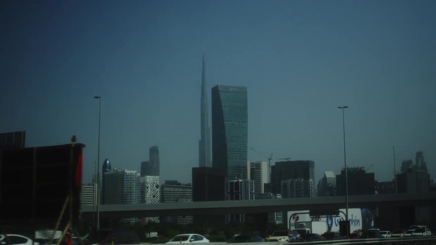 Urban view of dubai with burj khalifa at the center and modern skyscrapers surrounding it under a clear sky