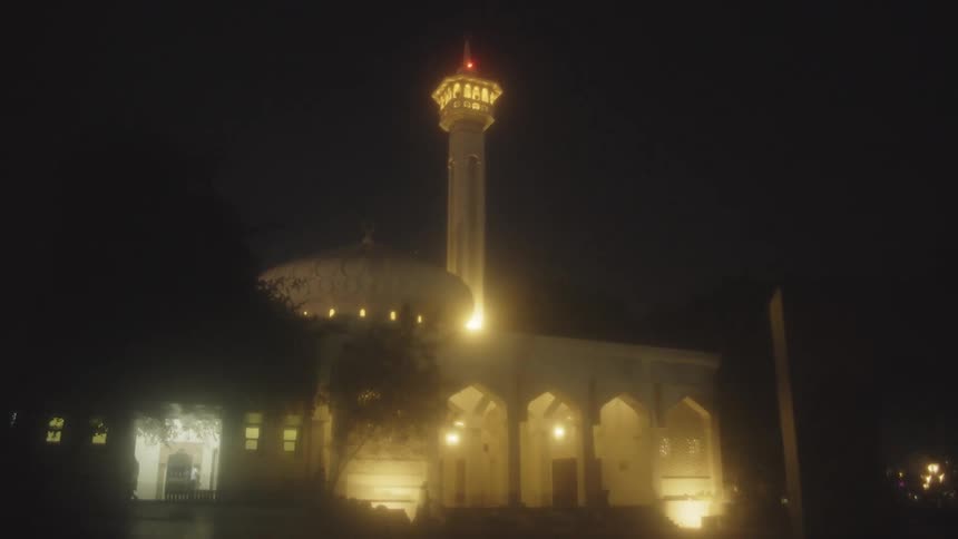 People walk outside the church at night