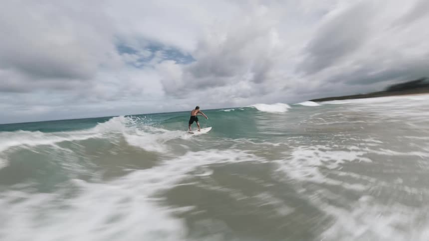 The man is cutting back and forth fast as he surfs a wave
