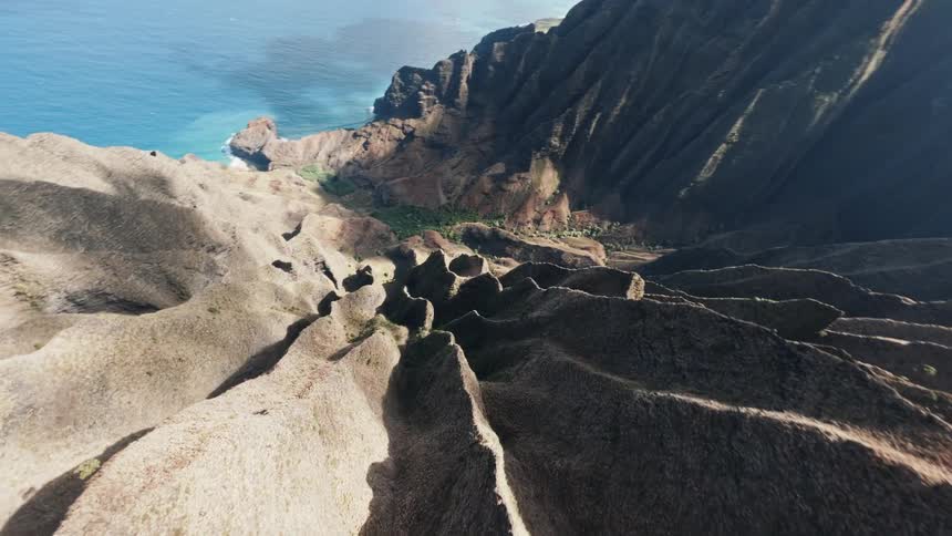 Looking down very steep cliff to ocean coast below