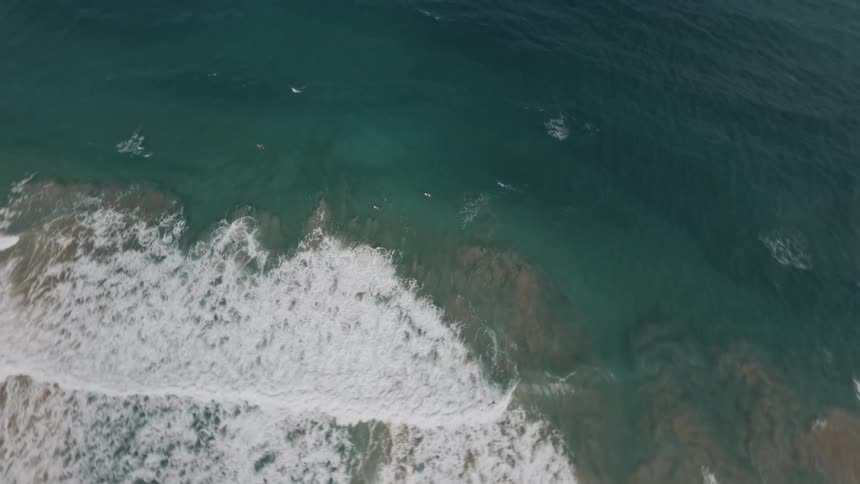 People are surfing by the shore