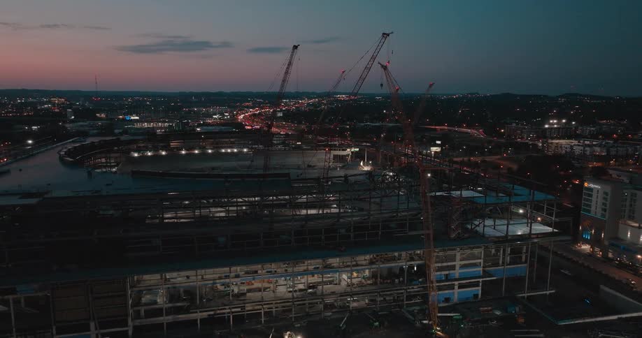 Aerial of a stadium arena in a large citys downtown area under construction work