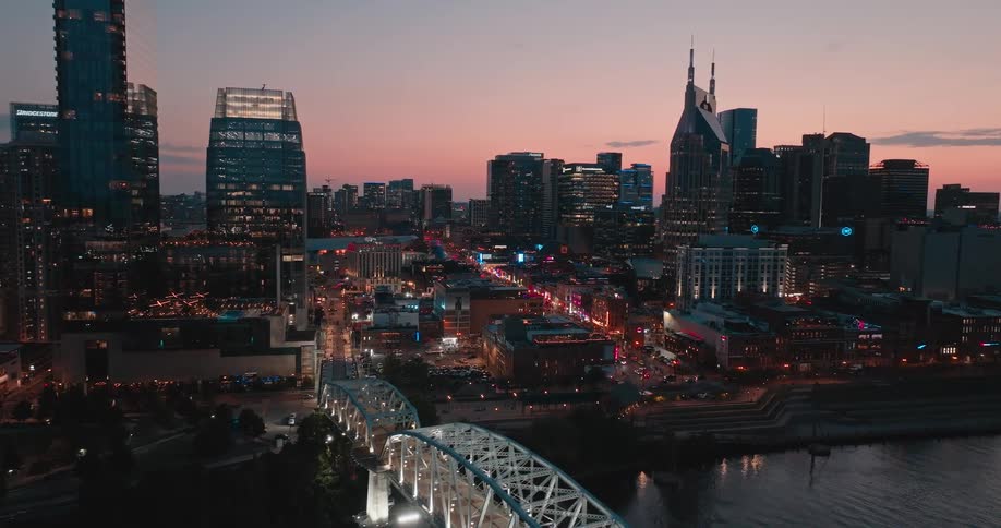 Traffic moves along city streets near the waterfront at night