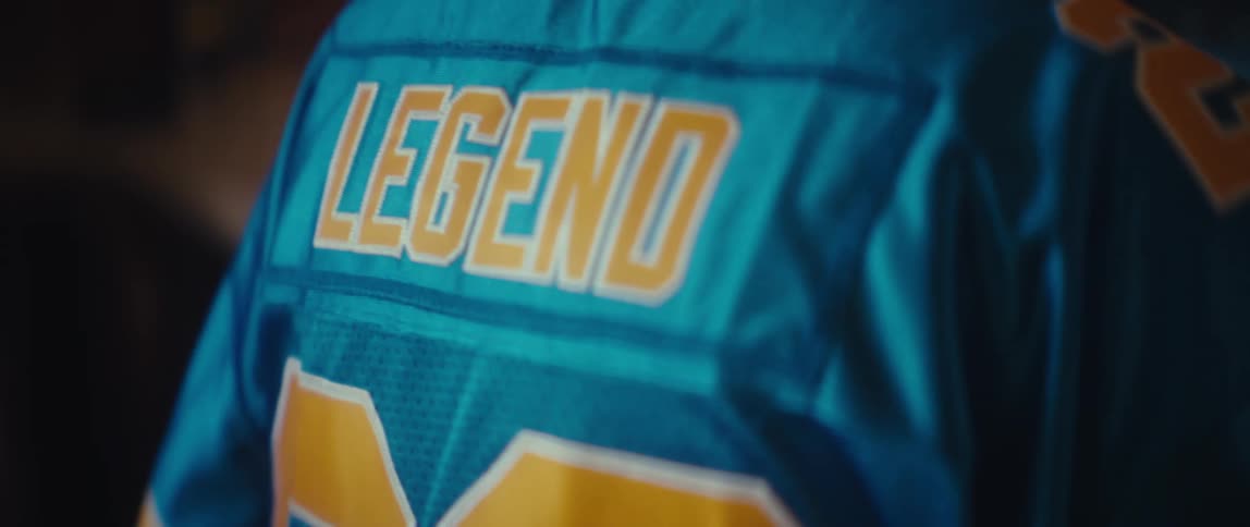 Number 28 and the word legend appear on the back of a blue jersey seen up close