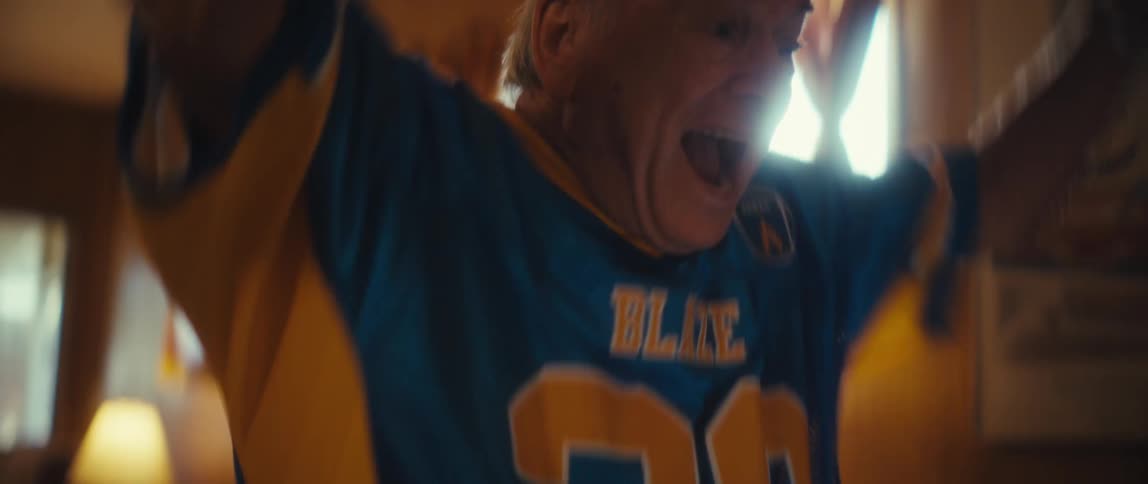 The man cheers at a sports game on his tablet