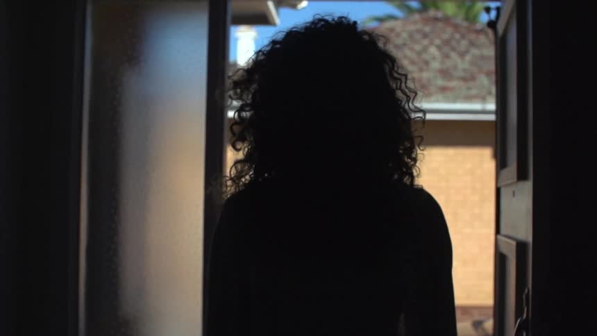 Woman moving through a door to go outside
