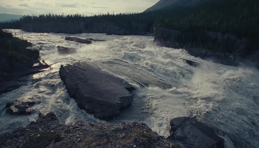 Turbulent waters of a powerful river rushing between rocks and cliffs