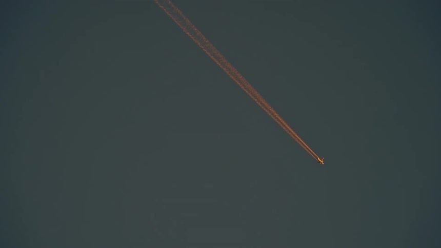 The plane descends leaving a vapor trail behind