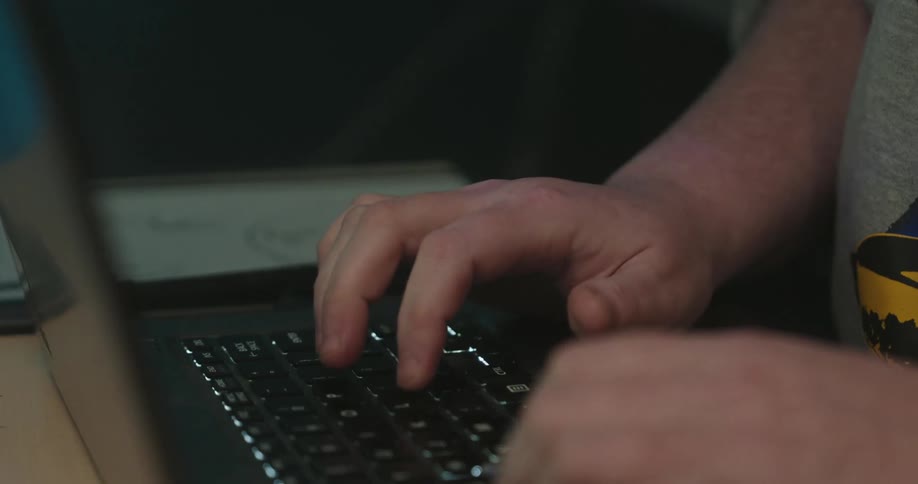 Woman marks a tablet with a stylus while typing on a laptop