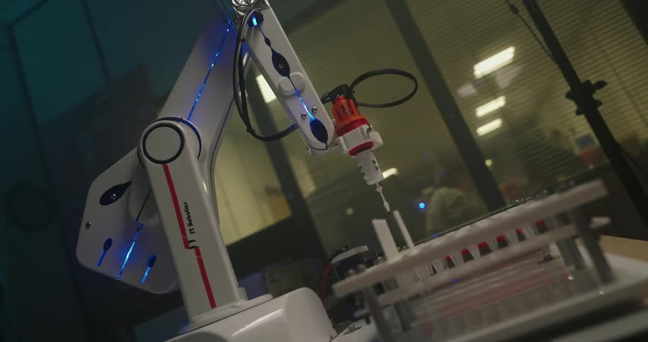 The robotic arm mixes the vials in the lab