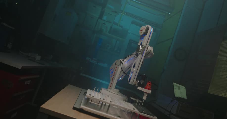 The robotic arm inserts a needle into holes in the device