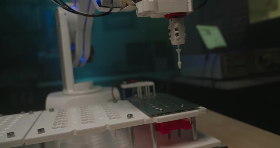 Close up of a robotic arm working on a table in a lab
