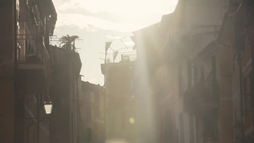 The sun flares over the apartments in the village