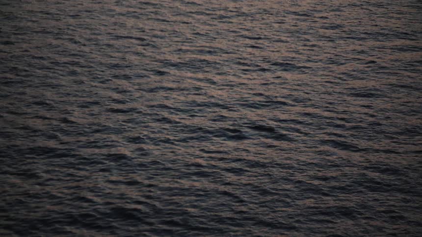 Aerial of a calm flowing water body outdoors at sunset