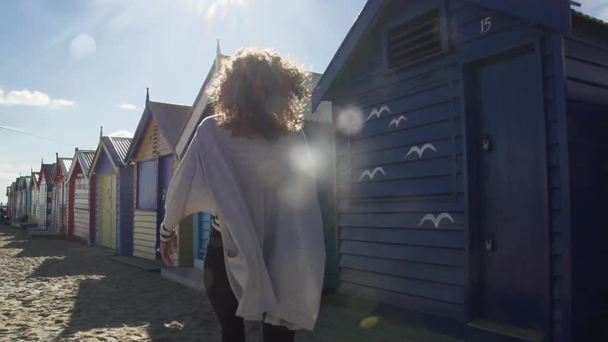 Woman walking towards colorful buildings