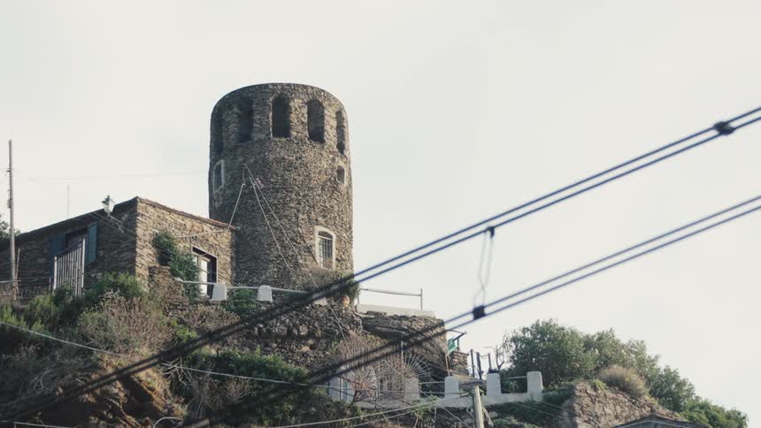 A stone tower is on the mountain
