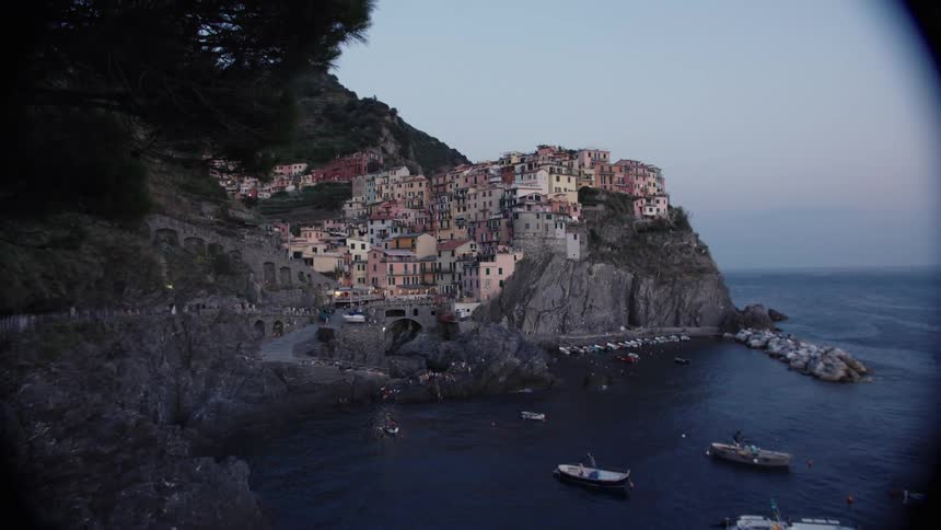 A coastal suburban city on a cliff by the sea at sunset