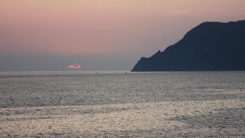 The sun is rising as the tide heads towards the mountains