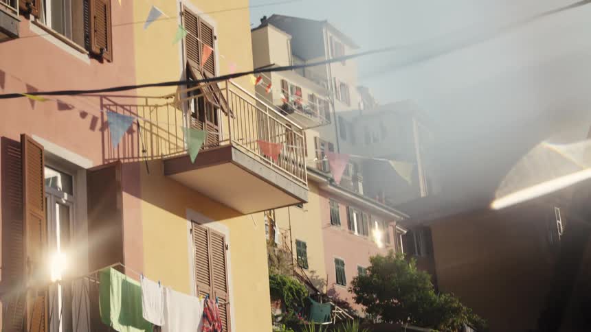 Afternoon sun lights up clothes hanging on a line in a residential building