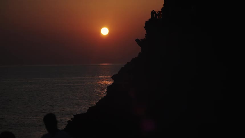 The setting sun reflects on the shore waters
