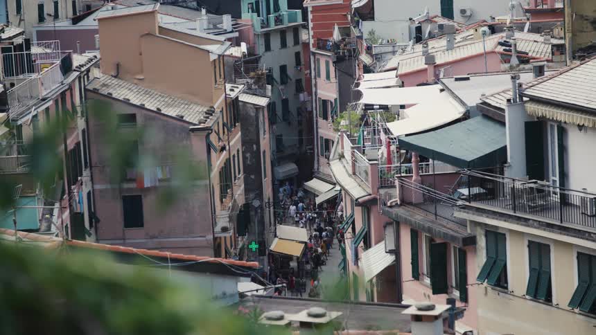 Pedestrians fill the alley in the village