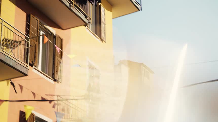 The sun reflects on the windows of the apartments