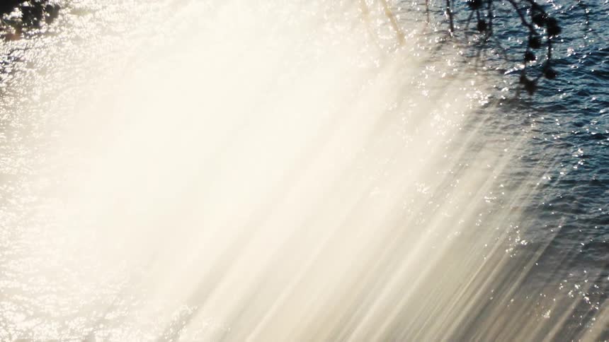 Beams of light shining over the shimmering surface of the water