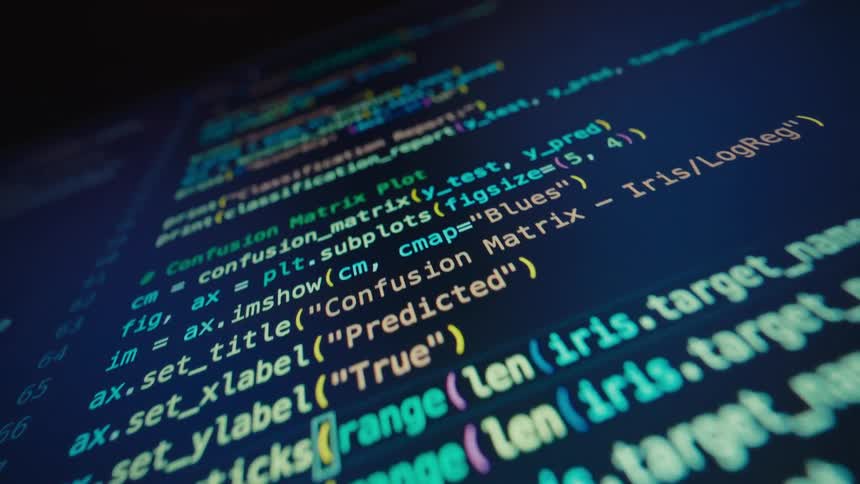 A medium closeup shot of a monitor screen displays a section of code in a dark theme with bright multicolored syntax highlighting the code includes elements related to machine learning and data visualization such as predicted values a confusion m