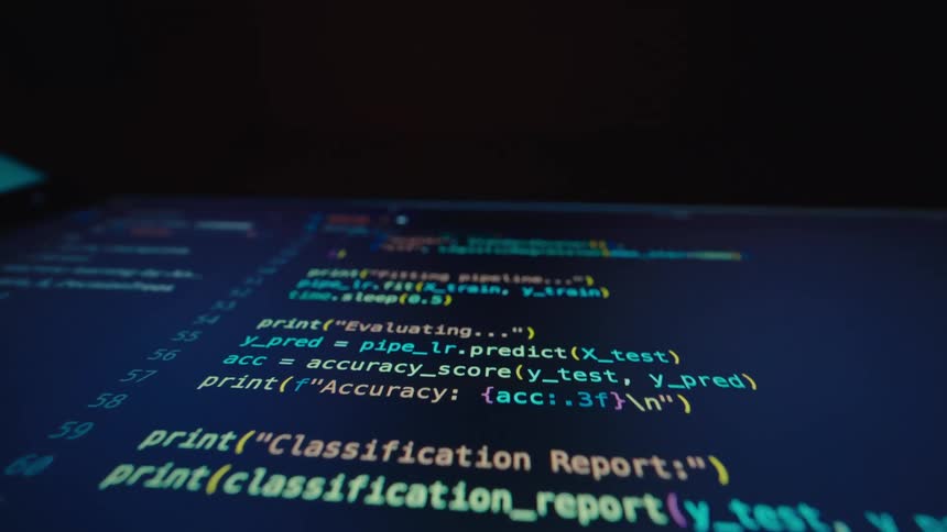 The computer screen is full of code