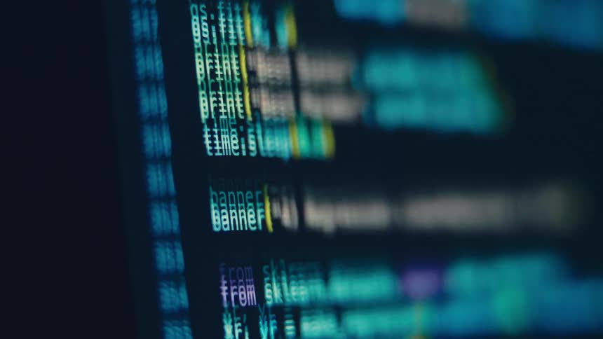 Closeup of a computer screen scrolling lines of colorful programming code