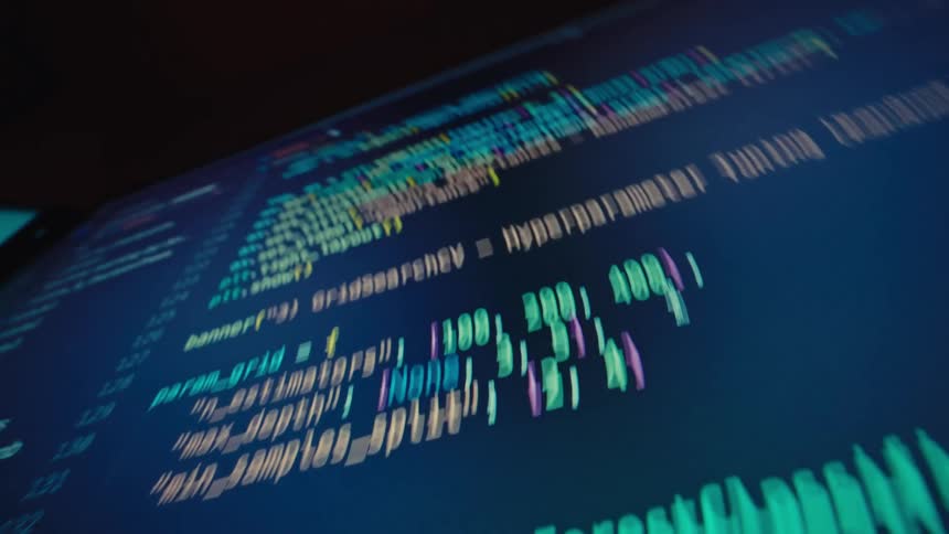 The computer screen is filled with computer code and text