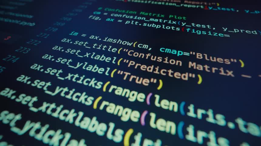 A scrolling closeup shot shows a screen displaying lines of python code primarily for machine learning tasks like fitting logisticregression and calculating accuracyscore the code features contrasting colors like yellow cyan and orange syntax hi