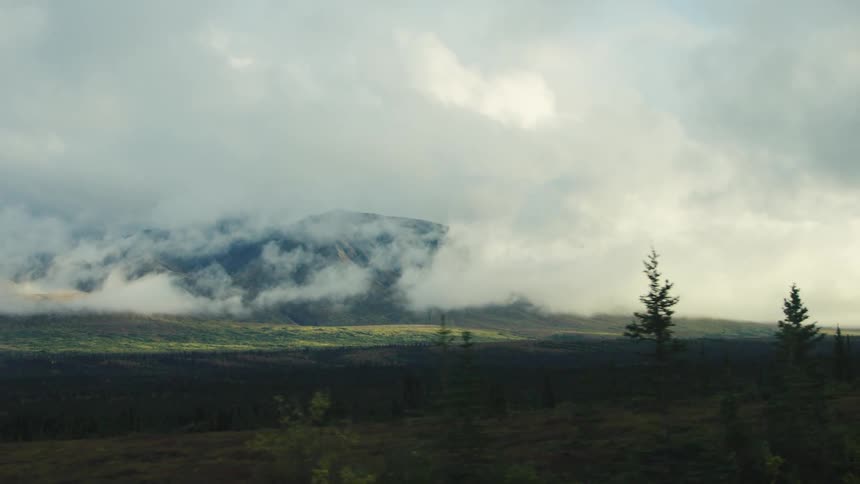 Heavy fog and clouds cover the mountains in he distance