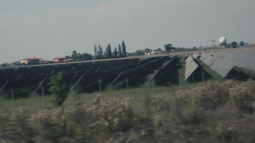 Vast area of solar panels aligned in the middle of a rural field