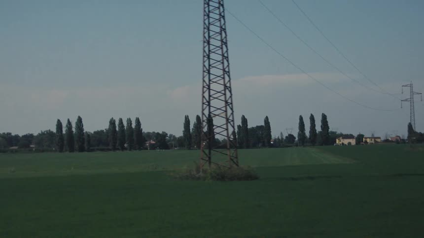 A large green field in a rural landscape during daytime