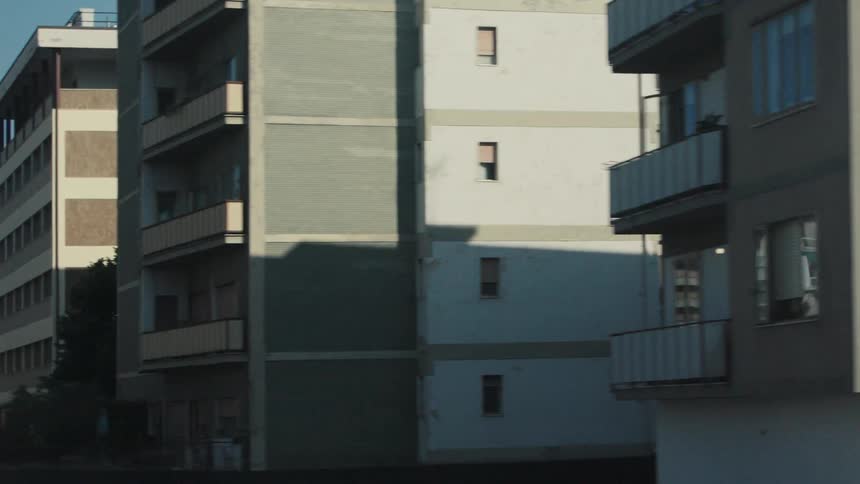 The apartment buildings have balconies in the city