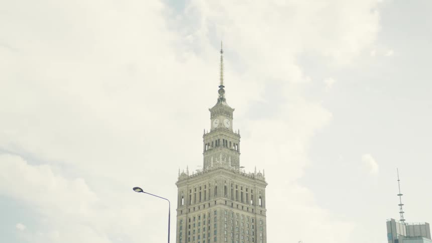 Historic skyscraper with a pointed tower stands out against the clear sky