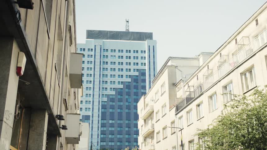 A blue high rise building in a metropolitan city during daytime