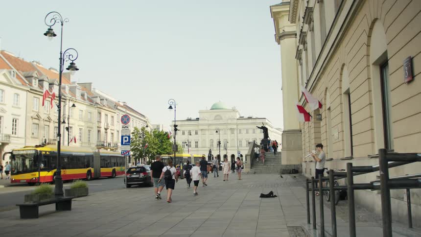 A busy sidewalk with multiple people walking in a metropolitan city during daytime