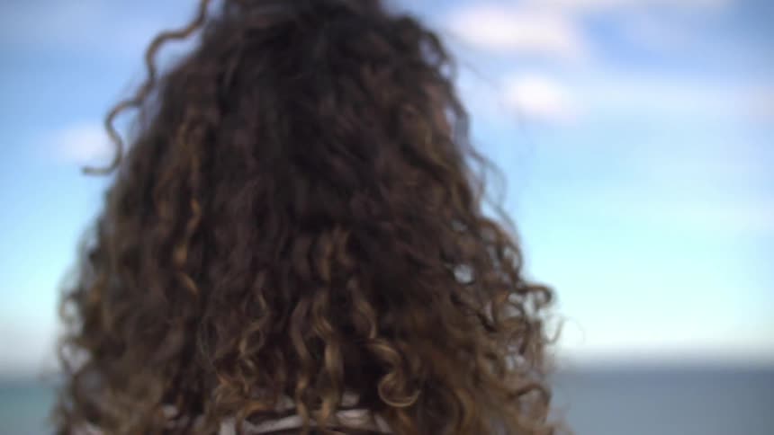 Woman moves her head around as the wind blows