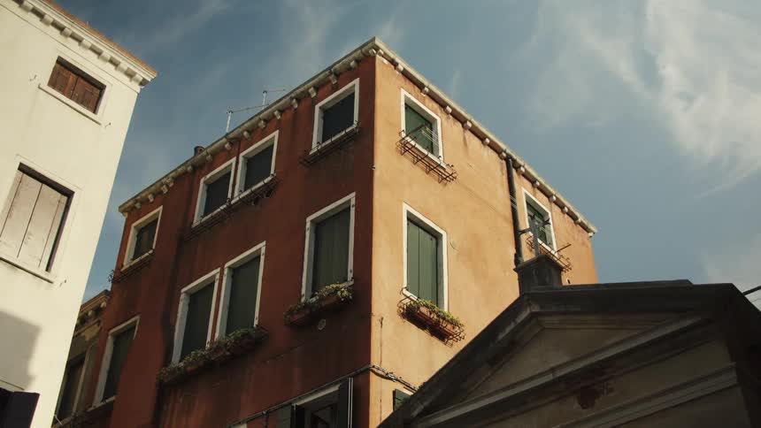 A brown multi storey building in a suburban city during daytime