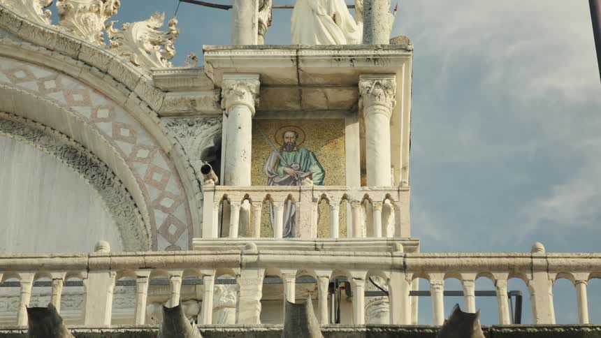 Religious mosaic panel decorates the ornate balcony of a historic building