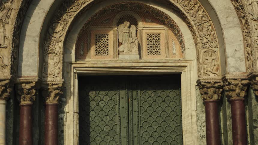 The man walks by the arched doorway