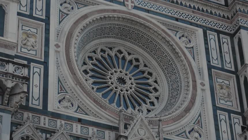 Elaborate architectural decorative elements both cover and surround a circular window