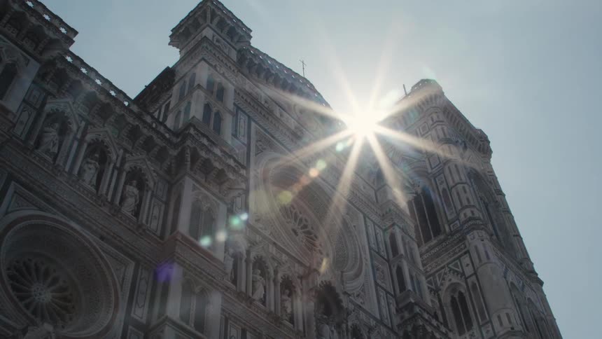 The sun flares over the tall church