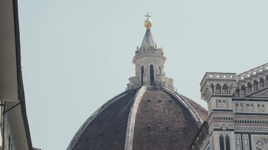 The domed church has a gold cross at the top