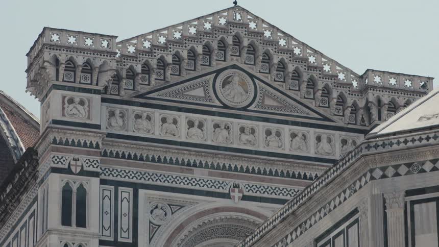 Detailed cathedral facade with sculptures and geometric marble patterns
